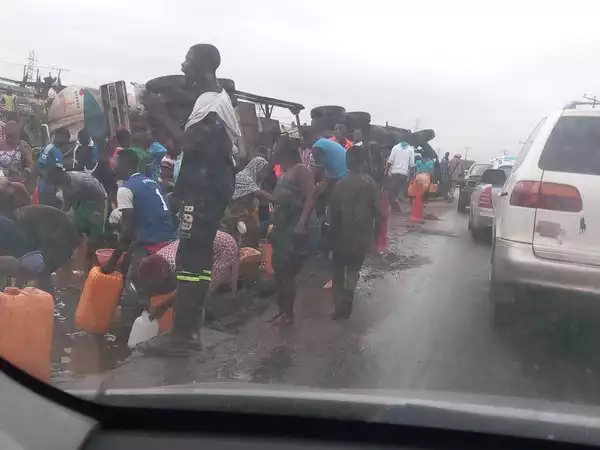 Unbelievable Photo Of People Scooping Fuel From Fallen Tanker In Lagos